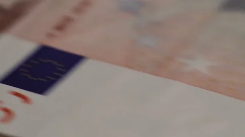 Macro shot of rows of euros with a dollar bill in the middle Stock Footage 79974934