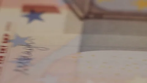 Macro shot of rows of euros with a dollar bill in the middle Stock Footage 79974944