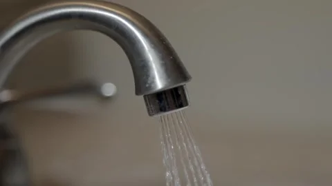 Macro shot of running water from chrome faucet during domestic chores Stock-Footage 334222104