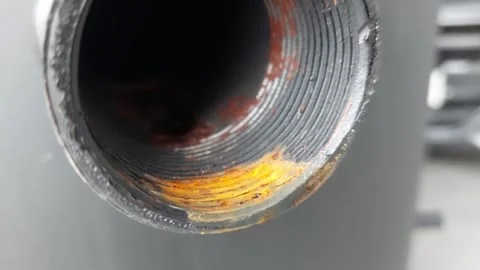 Macro shot of a rusty metal pipe thread on a black industrial tank Stock Footage 335401749