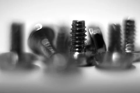 Macro shot of screws, real motion blured (no cg), shallow dof. Stock Photos