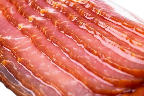 Macro shot several rows of sliced smoked bacon isolated on white background. Foto stock