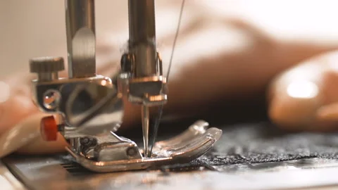 Macro shot on sewing machine needle sews silk fabric. Stock Footage 102656589