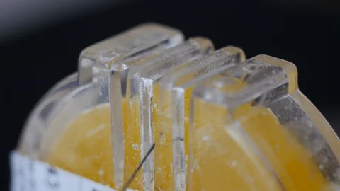 Macro shot of sewing thread passing through beeswax block. waxed thread is Stock Footage 128135999