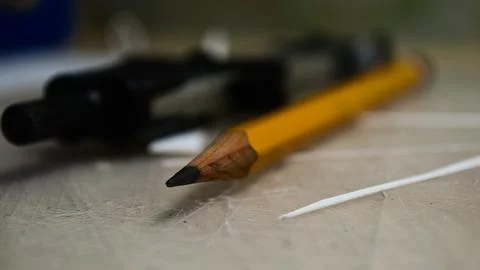 Macro shot of a sharp graphite pencil on a workspace table Stock Photos