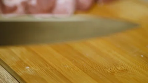 Macro shot of sharp knife slicing raw meat steak Stock Footage 340078036