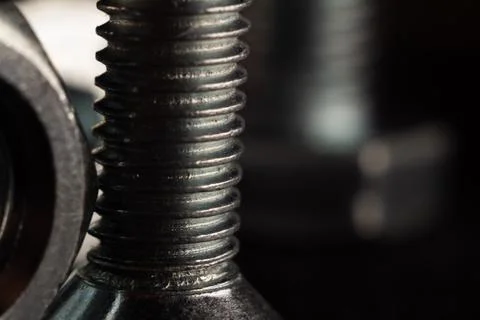 Macro shot of a shiny black solid screw in a big set with a blurry background Foto stock