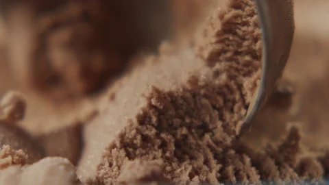Macro shot сhocolate ice cream scooped out from container with silver spoon Stock Footage 120017049