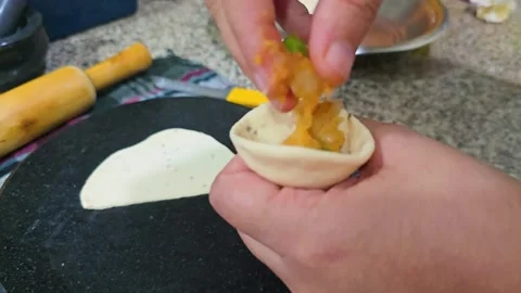 Macro shot showing indian snack samosa being prepared with potato filling in a Stock Footage 331314503