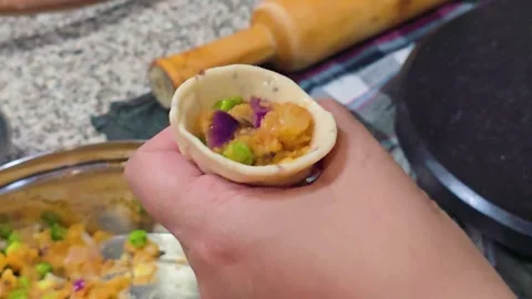 Macro shot showing indian snack samosa being prepared with potato filling and Stock Footage 331314580