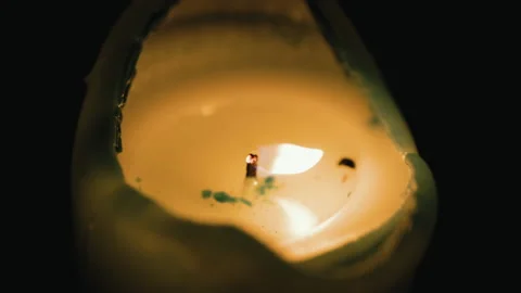Macro shot of Single blow out a candle indoor at home in dusk. Video stock 235563743