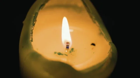 Macro shot of Single candle burns indoor at home in dusk. Stock Footage 235563704