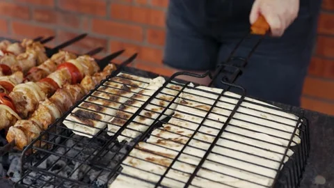 Macro shot of sizzling shish kebabs cooking outdoors Stock Footage 343385381