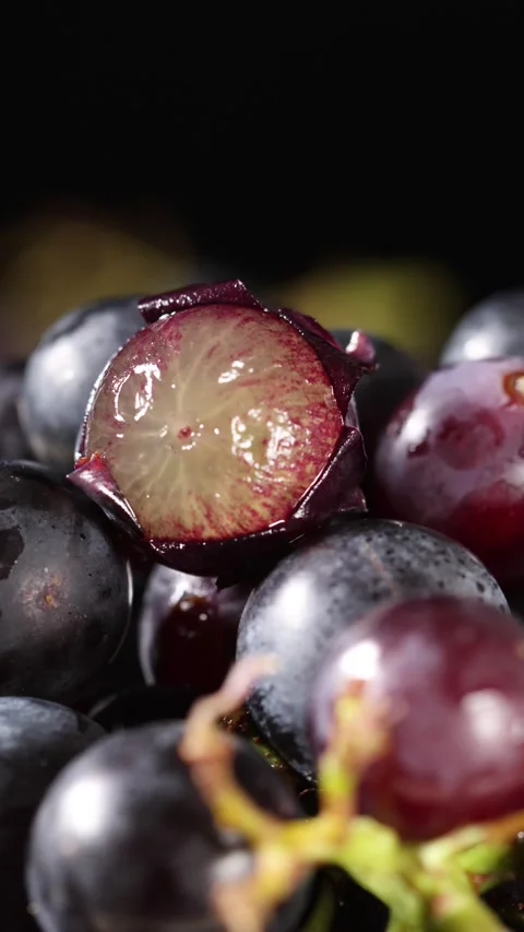 Macro Shot of Sliced Juicy Grape Rotating on Dark Background Stock Footage 341926531