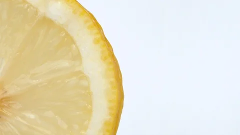 Macro shot sliced lemon. Drop of juice flowing down the edge Stock Footage 124130402