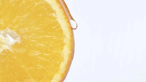 Macro shot sliced orange. Drop of juice flowing down the edge Stock Footage 124130505