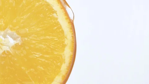 Macro shot sliced orange. Drop of juice flowing down Stock Footage 124130525