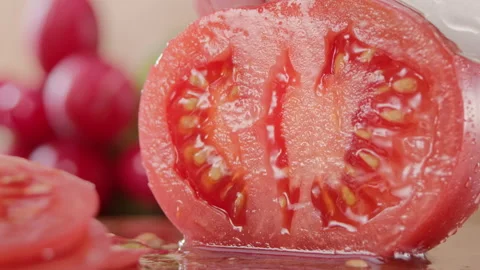Macro shot of slicing a tomato. Chef's knife cutting vegetables. Organic food Stock Footage 151795146
