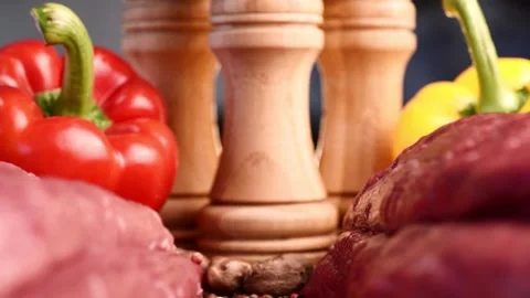 Macro shot of slide between two raw beef fillets on wooden board with colorful Video stock 152112797