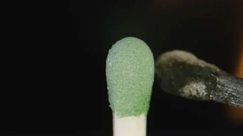 Macro shot in slow motion of burning match lighting up another one 動画素材 132217614