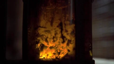 Macro shot in slow motion of tea leaves floating in boiling water in a teapot Stock Footage 171253185