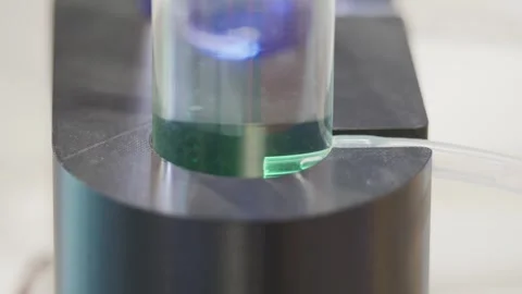 Macro shot of small hydrogen bubbles emerging from transparent tube inside Видео 335314951