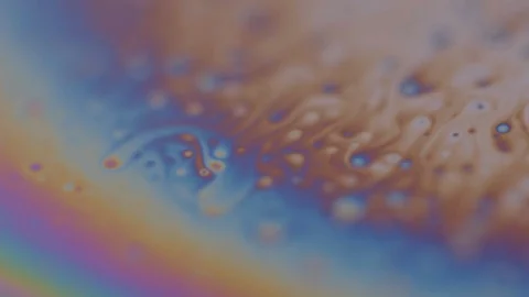 Macro shot of small objects moving on a rainbow colored sphere. Sphere Video stock 128574817