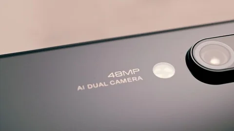 Macro shot of a smartphone camera module from behind in black placed on a blue Stock Footage 114315363