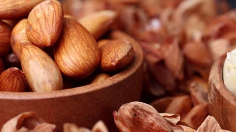 Macro shot of Soaked n peeled almonds in a rustic wooden bowl surrounded by.. Stock Footage 334728820