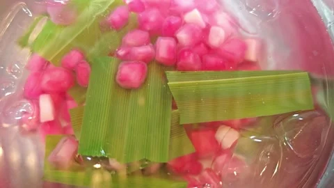 Macro shot of soaking cooked water chestnut rubies in ice water. Stock Footage 342403969