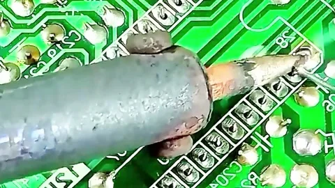 Macro Shot of Soldering Electronic Components on Circuit Board Stock Footage 333503818