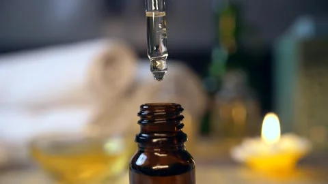 Macro shot of a spa oil test by taking in a dropper - spa session, almond oil... Stock Footage 264033598