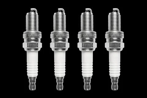 Macro shot of spark plug isolated on black background. A spark plug for an .. Stock-Fotos