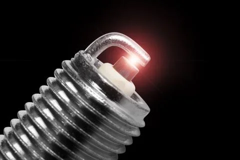 Macro shot of sparks on spark plug isolated on black background. A spark pl.. Stock Photos