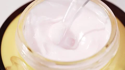 Macro shot of spatula scooping soft pink face cream from a cosmetic jar. Id.. Stock Footage 315032790