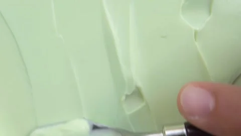 Macro Shot of Spatula Swiping Creamy Pale Green Cosmetic Stock Footage 340851237