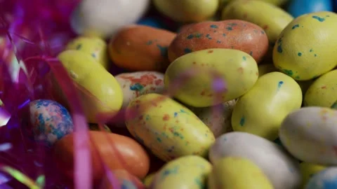 Macro shot of speckled easter egg candies in tinsel Stock Footage 328136367