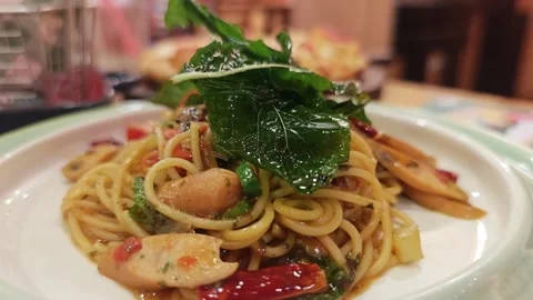 Macro shot of spicy Thai spaghetti with sausages and crispy basil. Stock Footage 340201322