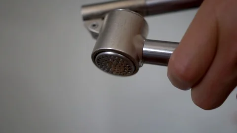 Macro shot of squeezing garlic out of garlic press Stock Footage 95447208