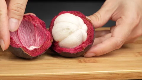 Macro Shot Squeezing Ripe Mangosteen Fruit In Half By Hand Stock Footage 336228008
