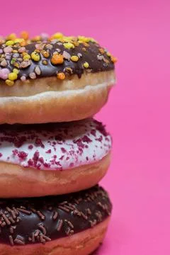 Macro shot of stack of donuts Macro shot of stack of donuts over pink back... Stock Photos