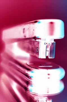 Macro Shot of Stapler with Red and Pink Glow Stock Photos