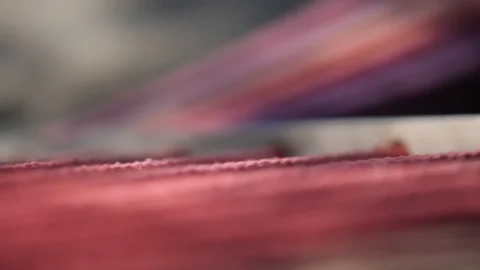 Macro shot of the strings on a red hammock wavering back and forth as rays Stock Footage 115057046