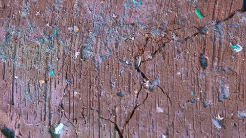 Macro shot of the surface of old red brick with deep vertical furrows, cracks Photos