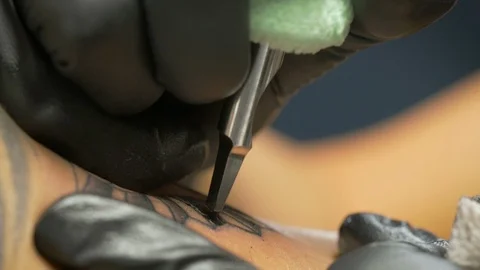 Macro Shot of Tattooing With a Tattoo Machine in 4k Stock Footage 96633462