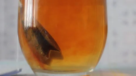 Macro Shot of Tea Extract Diffusing in Glass Stock-Footage 347393671