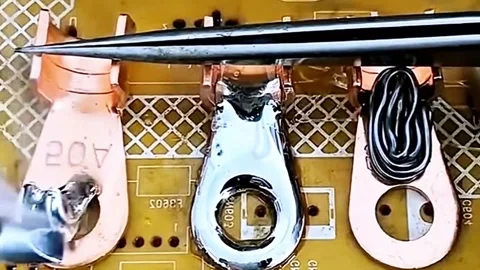 Macro Shot of Technician Soldering Tin onto Copper Wire Terminals Stock Footage 333553009