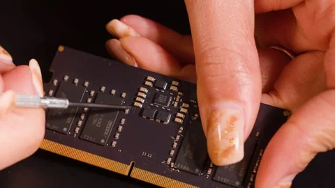 Macro shot of technician using precision tool on ram memory module circuit .. Stock Footage 334365470