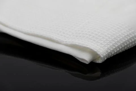 Macro shot texture of folded white towel kitchen fabric with copy space text Stock Photos