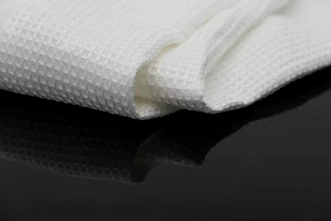Macro shot texture of folded white towel kitchen fabric with copy space text Foto stock